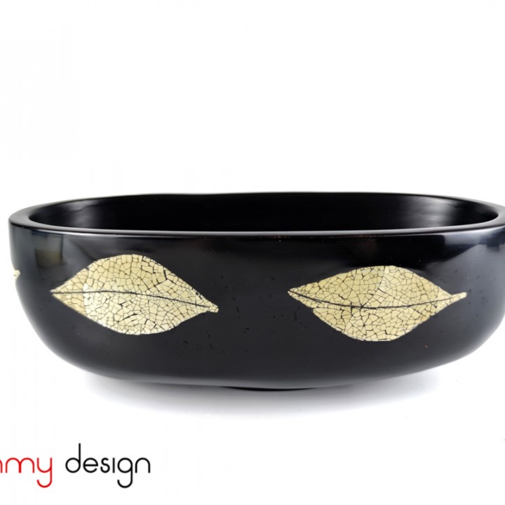 Black oval bowl attached with eggshell leaves